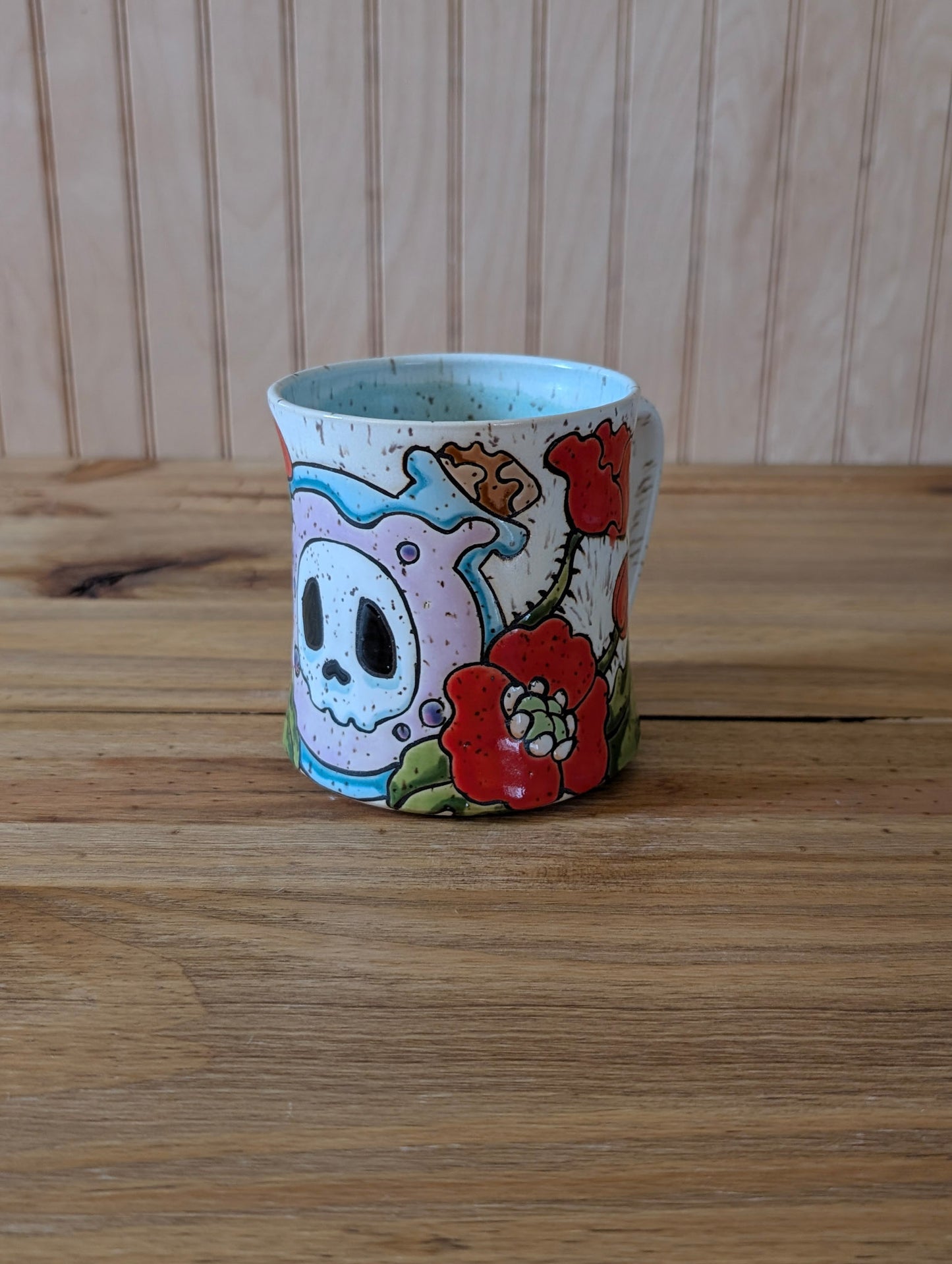 potion bottle with skull and poppies mug